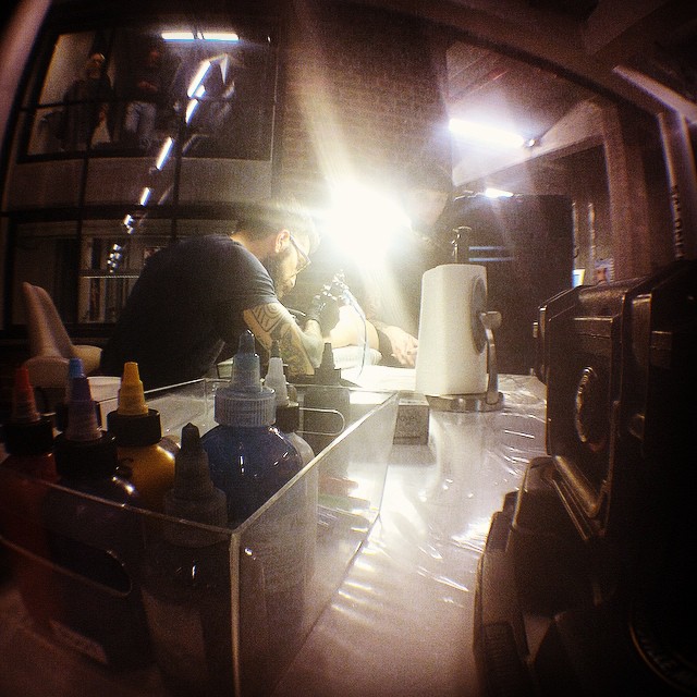@stef_bastian of @royaltattoodk working his magic on @karenaastrup in front of a...
